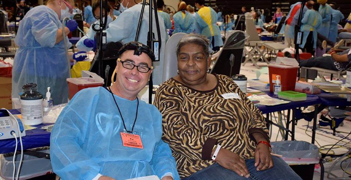 smiling volunteer and patient at dental clinic